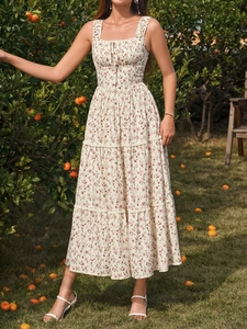 Detail of square neckline with ruffle trim and floral pattern on a summer midi dress