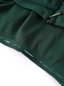 Macro detail of dark green dress showing invisible zipper and silicone non-slip grip strip