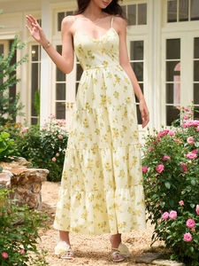 Détail de la jupe à volants et du motif floral sur la robe d'été longue jaune