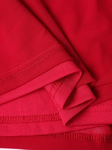 Detailed close-up showing overlock stitching on breathable red mesh fabric