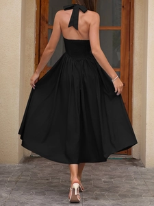 Detail of backless halter dress showing large bow decoration and smocked elastic waist