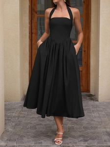 Detailed view of backless halter dress showing pleated high waist and hidden side pockets