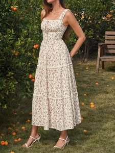 Close-up of tiered cottagecore floral maxi dress with square neckline and drawstring detail
