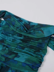 Detail of blue and green mesh dress featuring watercolor print and pleated texture