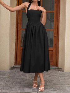 Detail of waist V-shape cut and ruching on a black halter neck midi dress