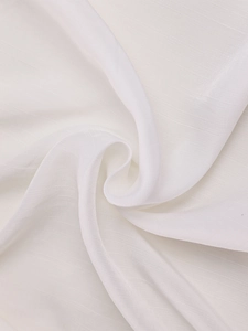 Close-up of pure white chiffon fabric with subtle texture and soft flowing drapes