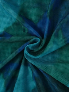 Detailed macro view of the blue and green gradient mesh fabric with a spiral texture