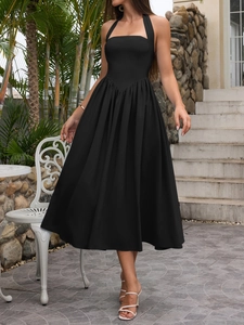 Close-up of elegant halter neck maxi dress featuring a V-shaped waist seam and flared hem
