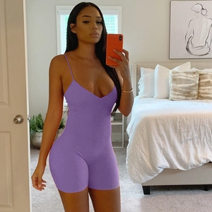 Mirror selfie showing a purple ribbed slim-fit romper with deep V-neck and thin straps