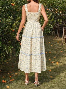 Detail of floral summer dress back with elastic smocked bodice and blue lace trim