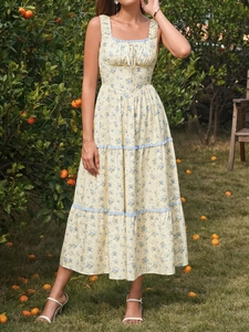 Close-up of square neck tiered floral dress with blue trim and ruffled bodice details