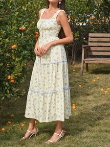 Detail of floral tiered maxi dress with blue lace trim and yellow print fabric