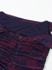 Close-up of floral mesh fabric with invisible zipper and ruched detail on a purple dress