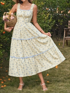 Detail of floral tiered maxi dress with square neckline and delicate tie-up bodice