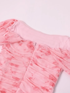 Close-up of pink ruched mesh fabric with high-quality invisible back zipper detail