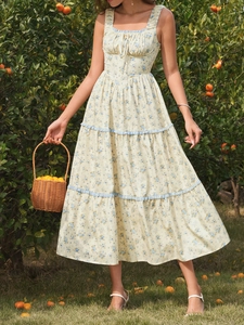 Detail of floral summer maxi dress with square neck and lace trim in an orange grove
