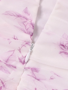 Close-up of white mesh dress with lavender floral print and hidden teardrop zipper
