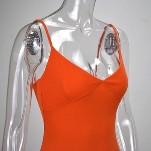 Detailed close-up of bright orange ribbed V-neck bodysuit fabric and strap design