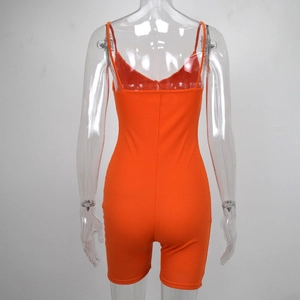 Detail of the back view of a bright orange ribbed knit spaghetti strap romper bodysuit