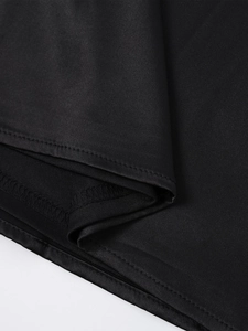 Detail shot of black satin dress hem with professional stitching and inner lining