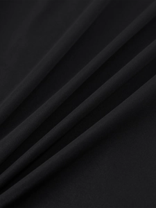 Close-up of black satin fabric with elegant soft folds and fine matte texture