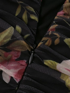 Detail of floral mesh dress featuring a hidden zipper and intricate pleated ruffles