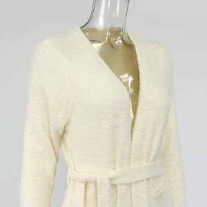 Detail of plush cream fleece bathrobe featuring a soft waist tie and v-neck design