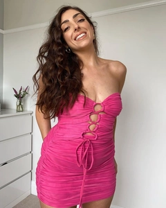 Detail of ruched rose pink mini dress featuring front cutout and metal ring detail