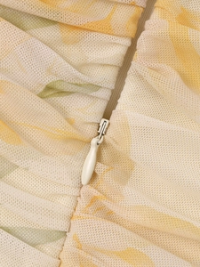 Close-up of the invisible zipper and pleated mesh fabric with floral pattern