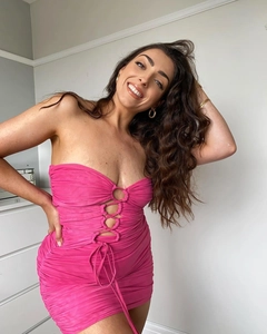 Detail of hot pink bodycon mini dress with ruched mesh fabric and cutout lace-up front