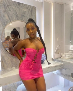 Detail of hot pink ruched mini dress showing criss-cross cutouts and drawstring ties