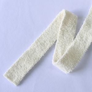 Detailed close-up of soft off-white plush waist belt with fuzzy sherpa texture