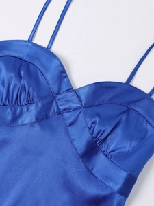 Detailed close-up of sapphire blue satin mini dress with thin straps and pleat details