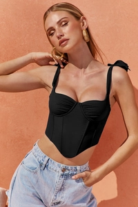 Detail of corset top featuring side view of boning structure and bow shoulder straps