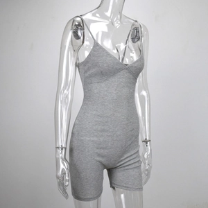Detail of grey ribbed knit romper featuring spaghetti straps and a deep V-neck design