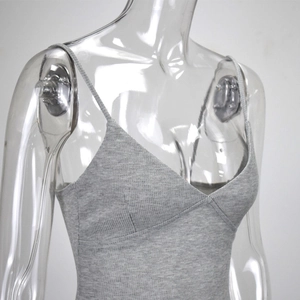 Detail shot of the gray ribbed knit texture and slim straps on the V-neck bodysuit