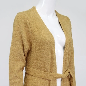 Detail of ginger yellow plush cardigan fabric texture and waist tie on mannequin