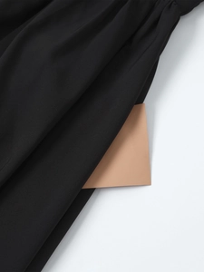 Macro shot showing the functional side pocket and fine weave texture of a black dress