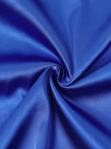 Detail of royal blue satin fabric showing smooth texture and metallic luster