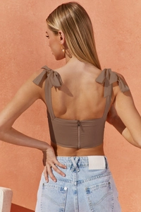 Detailed back view of brown corset crop top with ribbon straps and metal zipper