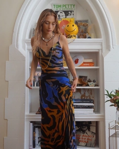 Detailed view of the flowing abstract print and silky texture on a long summer slip dress