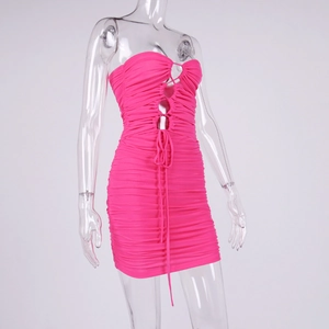 Detail view of rose pink ruched bodycon dress with hollow rings and lace-up design