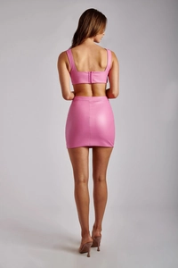 Rear view of pink PU leather two-piece set featuring cropped vest and slim mini skirt