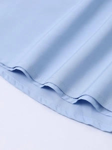 Detail shot of light blue fabric texture with twill weave and durable double-needle stitching