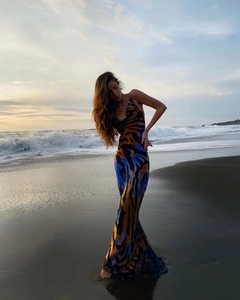 Detail of blue and yellow abstract tiger print maxi dress on a beach setting