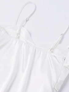 Detail of white satin dress featuring adjustable spaghetti straps and an invisible side zipper