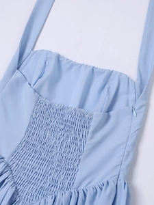 Detail of light blue smocked dress featuring elegant pleats and side hidden zipper