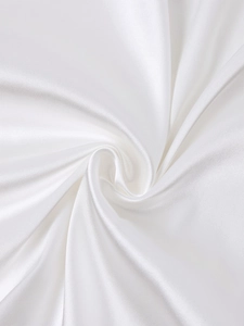 Macro detail of glossy white satin fabric showing smooth texture and elegant light reflections