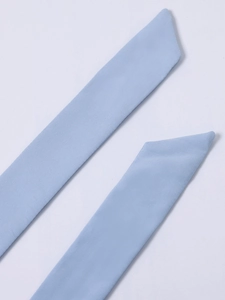Detailed view of light blue halter straps showing fine twill fabric and diagonal cut edges