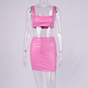 Detail of pink PU leather crop top and high-waisted mini skirt set on a mannequin